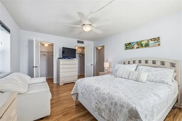 a bedroom with a bed and a television