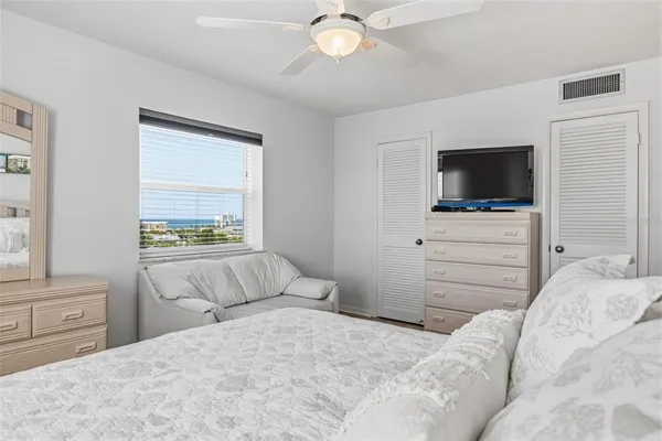 a bedroom with a bed and a flat screen tv in it