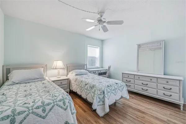 a bedroom with two beds and painting on the wall