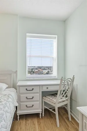 a bedroom with a bed and a chair