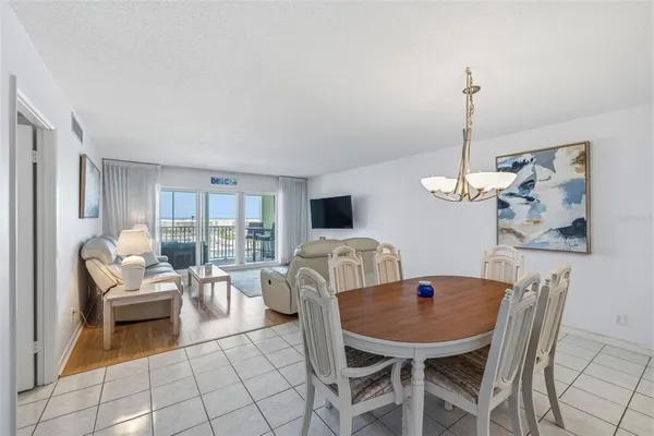 a living room with furniture a flat screen tv and a table