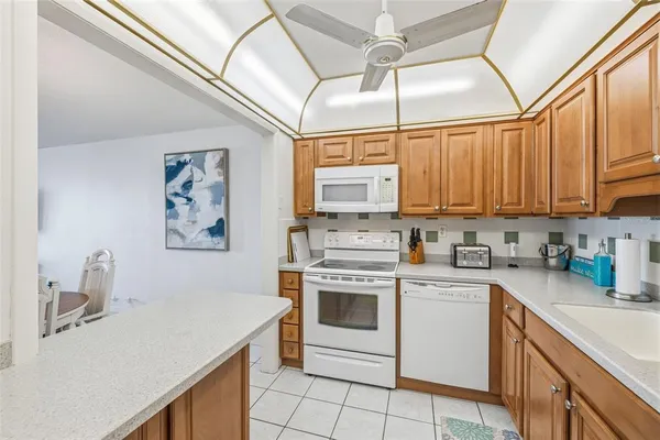 a kitchen with a sink cabinets stainless steel appliances and a window