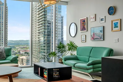 a living room with furniture and a potted plant