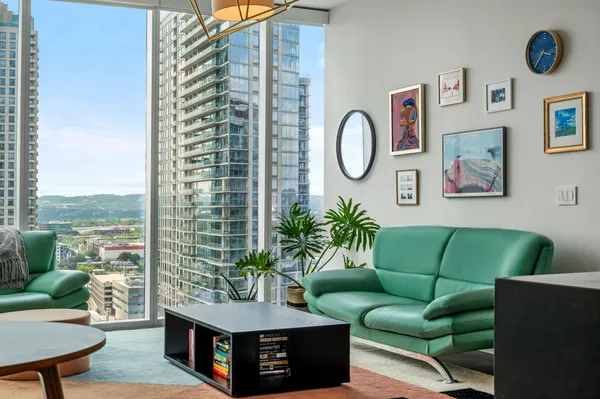 a living room with furniture and a potted plant
