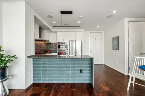a kitchen with stainless steel appliances granite countertop a refrigerator and a stove
