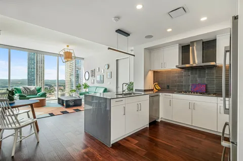 a kitchen with stainless steel appliances granite countertop a stove and cabinets