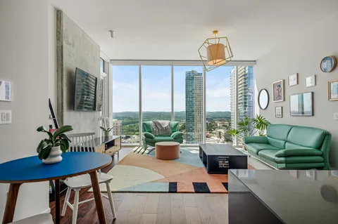 a living room with furniture and large windows