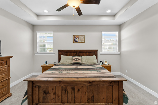 3678 Spiral Springs Road, Unit 204 Tooele, UT 84074 - Photo 26 of 59 Tray ceiling with recessed lighting and a ceiling fan, two windows with blinds, and light gray wall paint