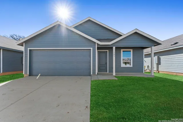 a front view of house with yard and green space