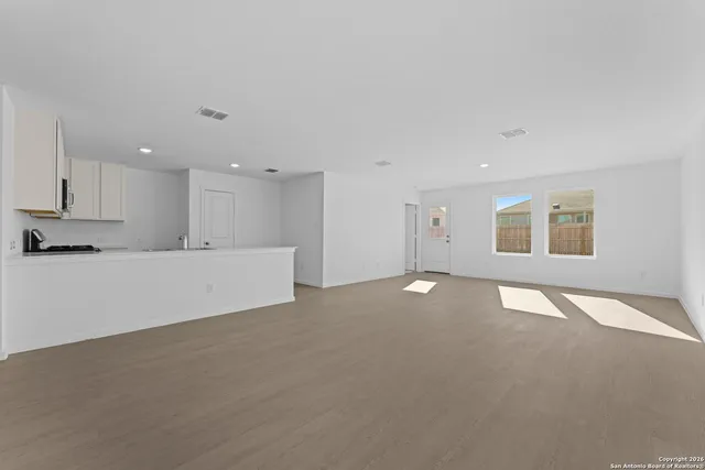 a view of kitchen with sink and refrigerator