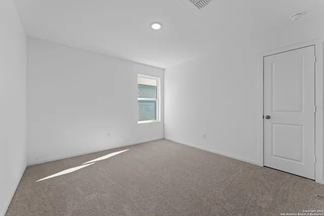 a bathroom with a toilet a sink a mirror a bathtub and vanity