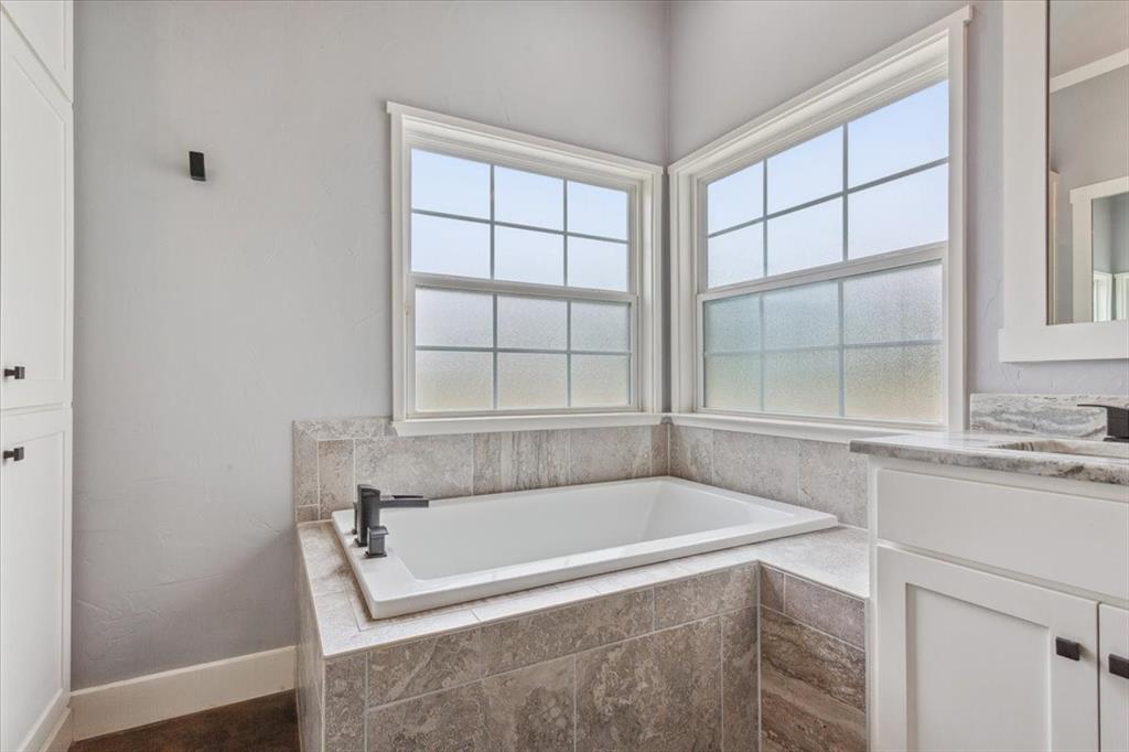 259 County Road 149 Riesel, TX 76682 - Photo 21 of 40 Full bathroom featuring a garden tub, vanity, and baseboards