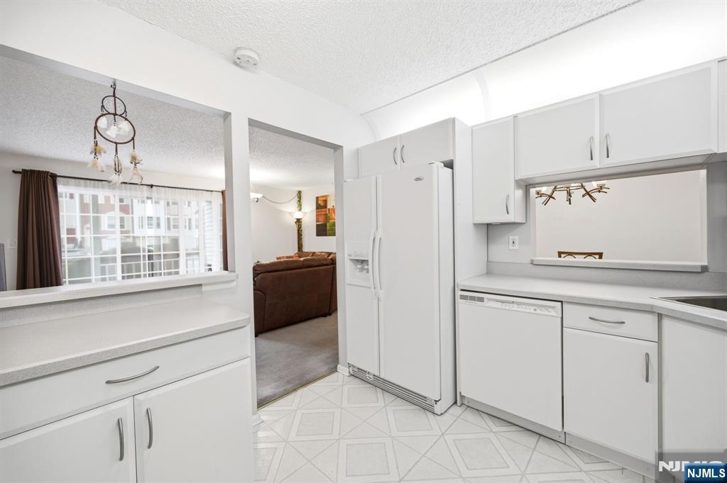 475 Quince Court Mahwah, NJ 07430 - Photo 11 of 27 a kitchen with white cabinets and appliances