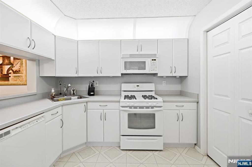475 Quince Court Mahwah, NJ 07430 - Photo 13 of 27 a kitchen with cabinets appliances a sink and a window
