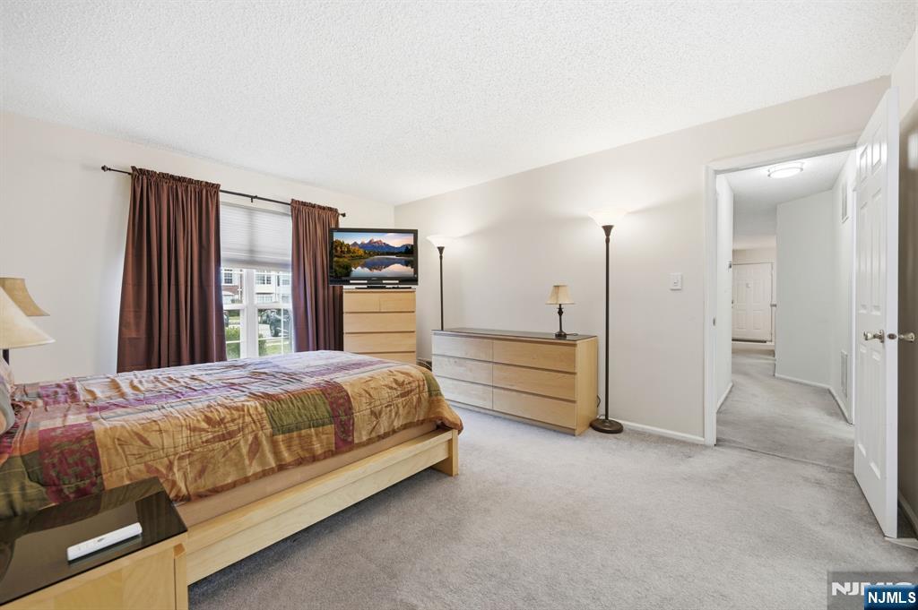 475 Quince Court Mahwah, NJ 07430 - Photo 16 of 27 a spacious bedroom with a bed and a large window