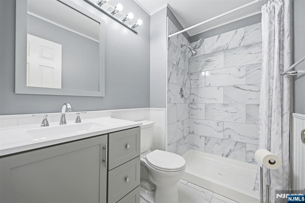 475 Quince Court Mahwah, NJ 07430 - Photo 18 of 27 a bathroom with a sink a toilet and shower
