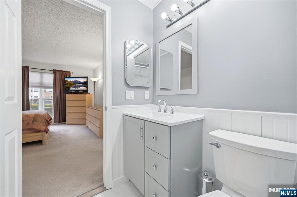 475 Quince Court Mahwah, NJ 07430 - Photo 19 of 27 a en suite bathroom with a sink a toilet and a mirror