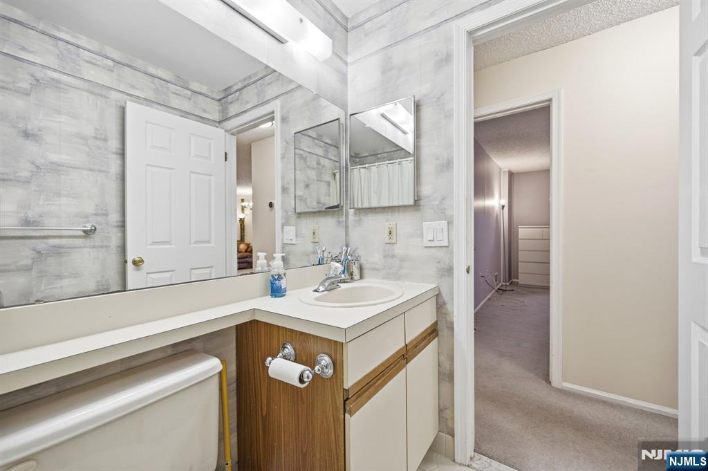 475 Quince Court Mahwah, NJ 07430 - Photo 23 of 27 a bathroom with a sink and a mirror