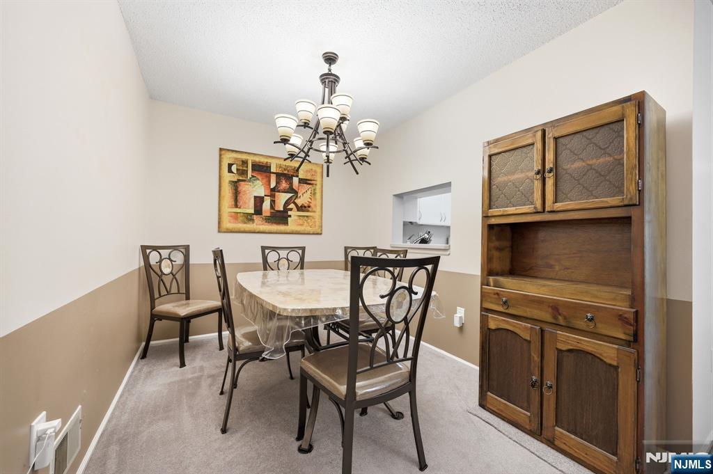 475 Quince Court Mahwah, NJ 07430 - Photo 5 of 27 a view of a dining room with furniture and chandelier