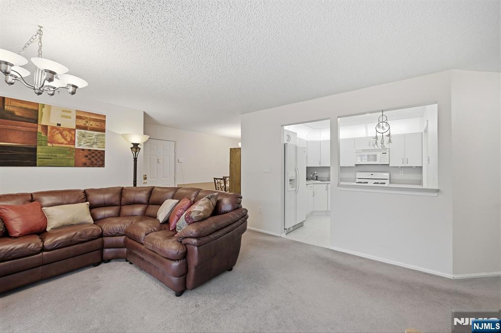 475 Quince Court Mahwah, NJ 07430 - Photo 6 of 27 a living room with furniture and a chandelier