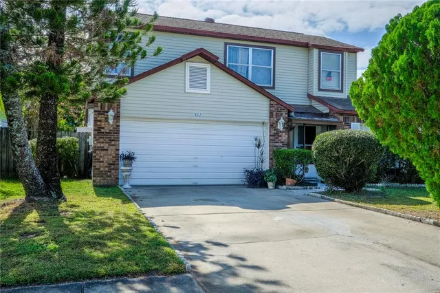 a view of a house with a yard and garage