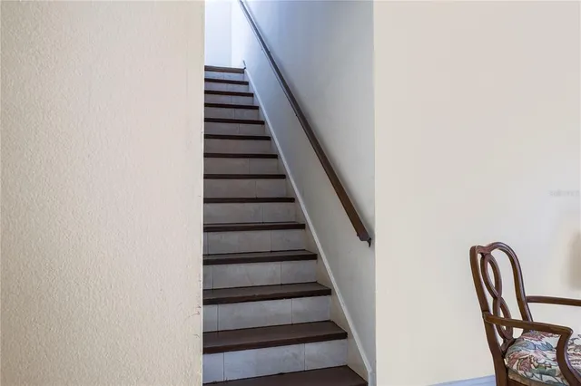 a view of a livingroom with wooden floor and a bathroom