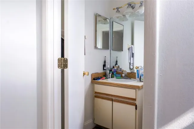 a bathroom with a sink a toilet and shower curtain