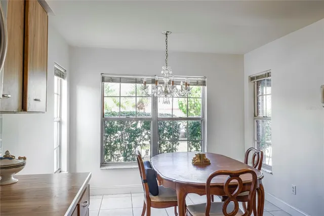 a dining room with furniture window and wooden floor