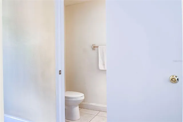 a white toilet sitting next to a white wall