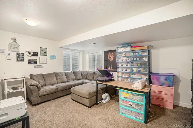 a living room with furniture and a bookshelf