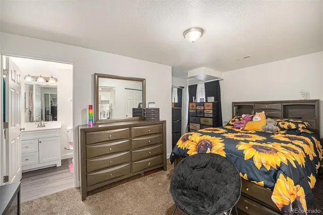 a bed room with a bed and a mirror