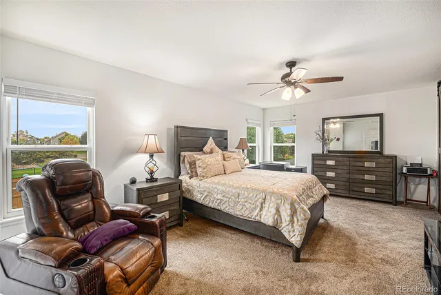 a bedroom with a bed window and couch