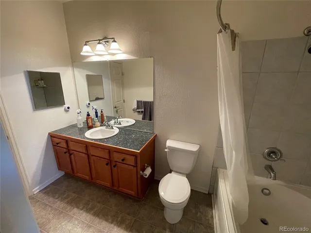 a bathroom with a double vanity sink toilet and shower