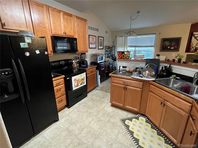 a kitchen with stainless steel appliances granite countertop a refrigerator stove top oven a sink and dishwasher