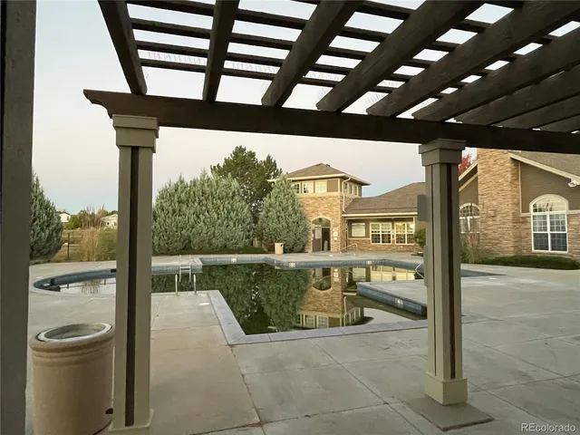 a view of a patio with a table and chairs
