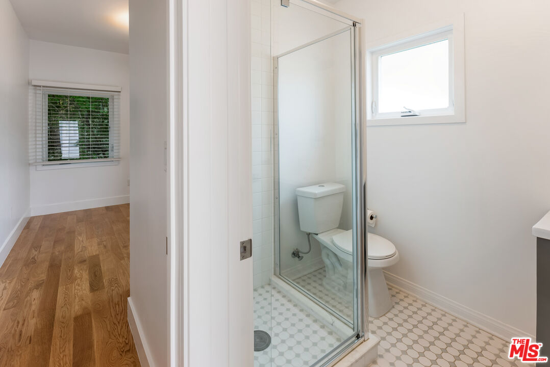 1253 South Rimpau Boulevard Los Angeles, CA 90019 - Photo 56 of 71 a bathroom with a toilet and a shower