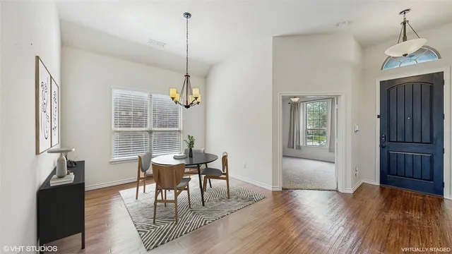 a living room with furniture a fireplace and a chandelier