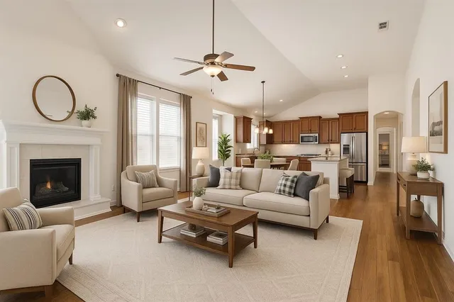 a kitchen with stainless steel appliances granite countertop a refrigerator a sink dishwasher a stove and white countertops with wooden floor