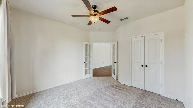 a bedroom with a bed and a couch