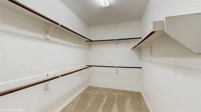 a spacious bathroom with a tub sink and mirror