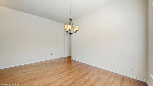 an empty room with a window and a ceiling fan