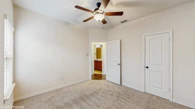 a bathroom with a sink toilet vanity and shower
