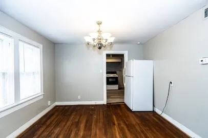 a view of a room with wooden floor and a window