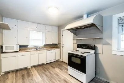 a kitchen with stainless steel appliances a stove sink and cabinets
