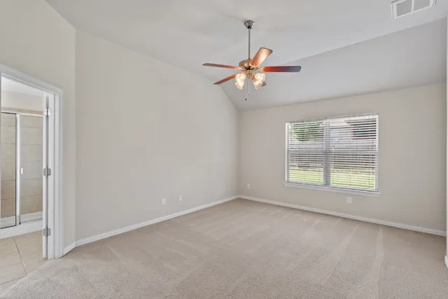a view of a livingroom with a ceiling fan and window