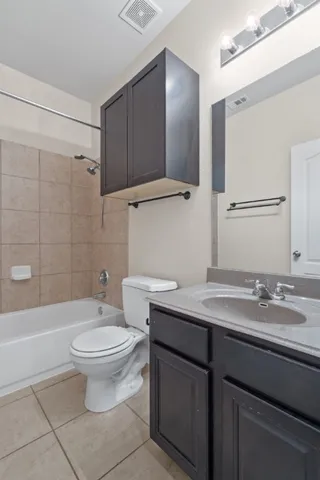 an empty room with windows and chandelier fan