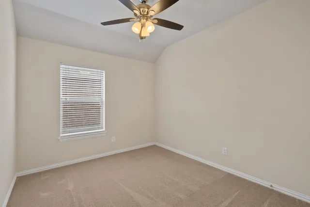 an empty room with a ceiling fan