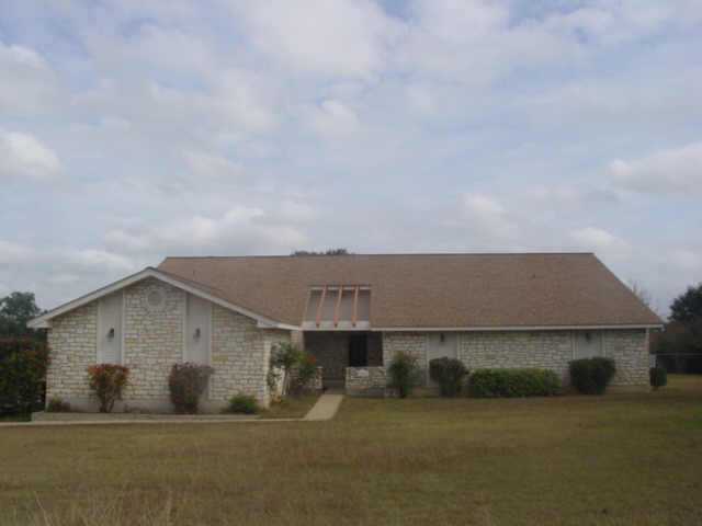 a backyard of a house with large trees