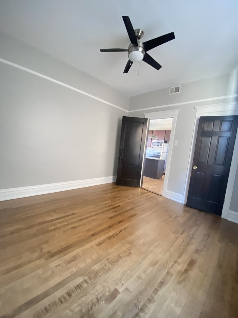 2898 North Milwaukee Avenue, Unit 2 Chicago, IL 60618 - Photo 5 of 10 a view of a livingroom with a ceiling fan