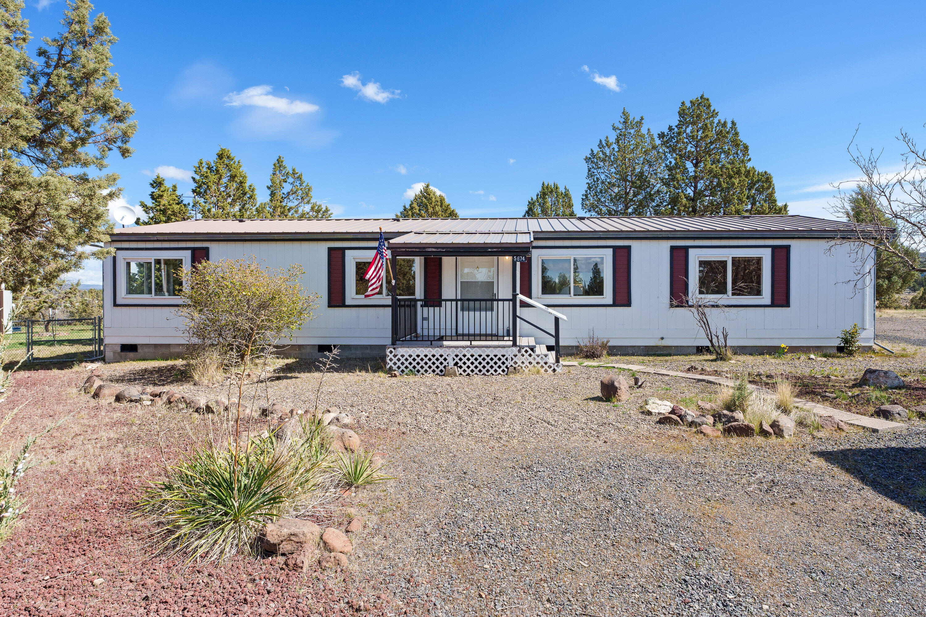 5674 Southeast Davis Loop Prineville, OR 97754 - Photo 2 of 48 a front view of a house with a yard